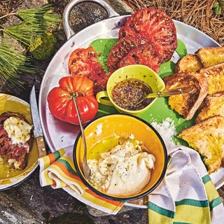 Cheese tomatoes and hot honey on a tray with toast.